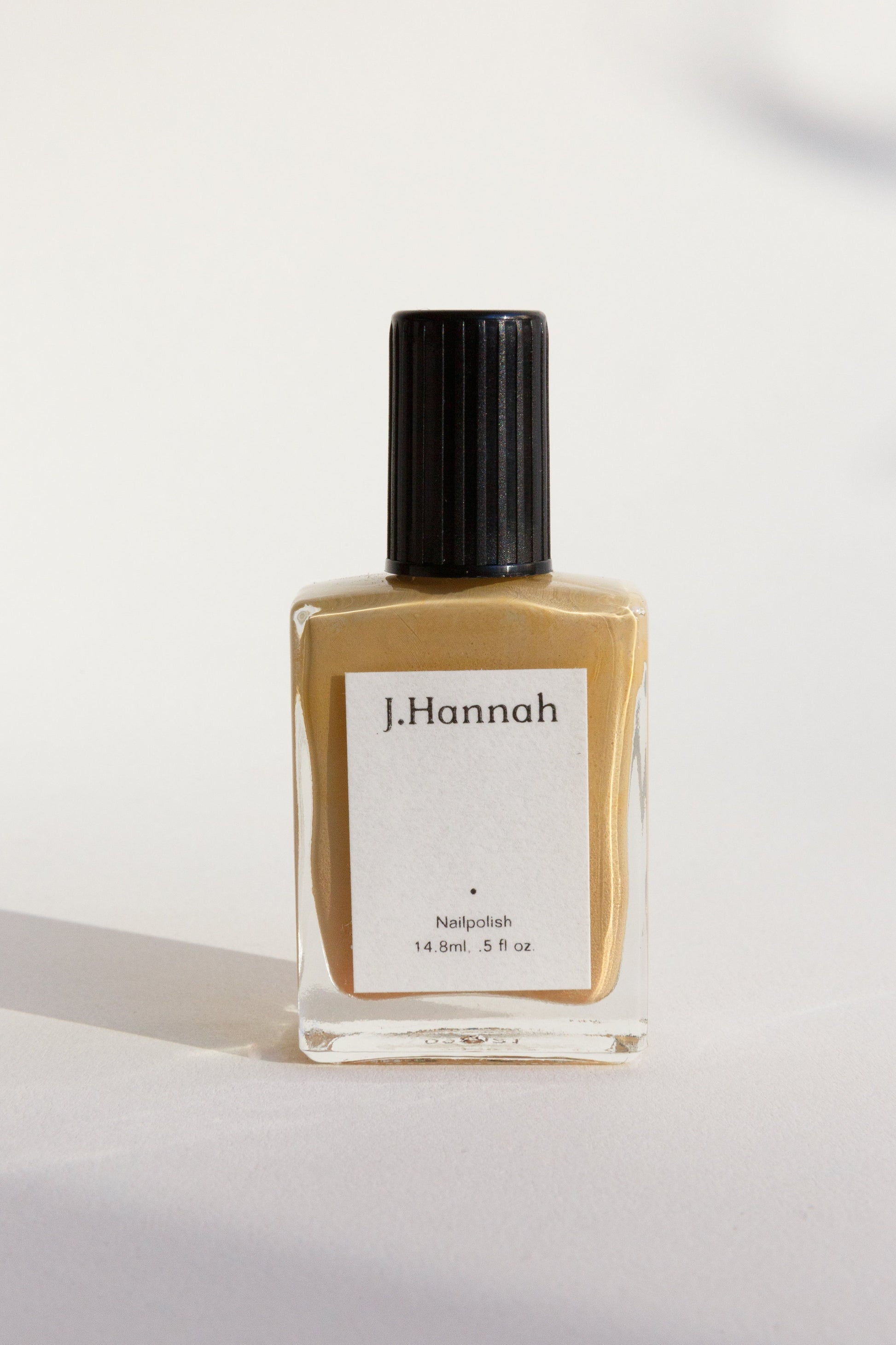A bottle of yellow nail polish by J.Hannah