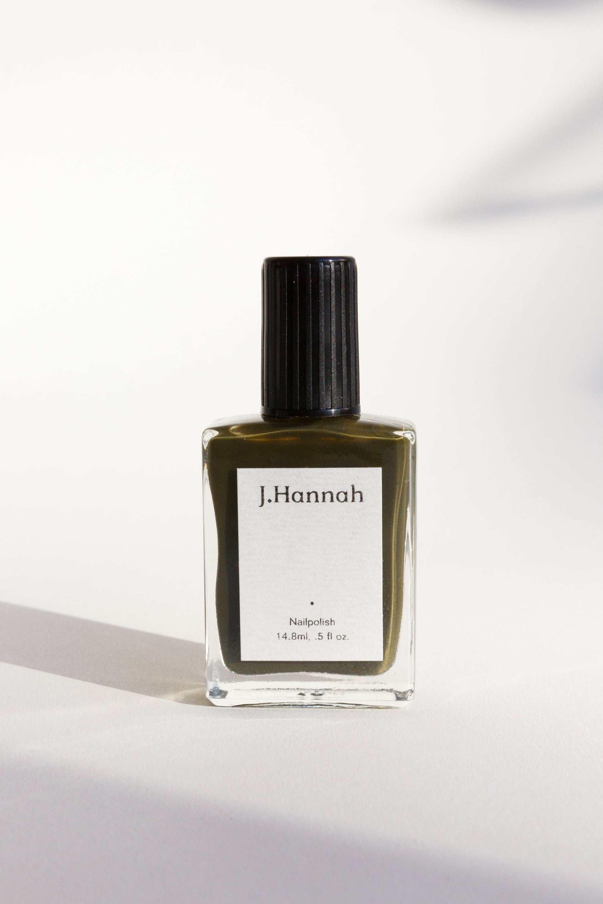 A bottle of dark olive green nail polish by J.Hannah