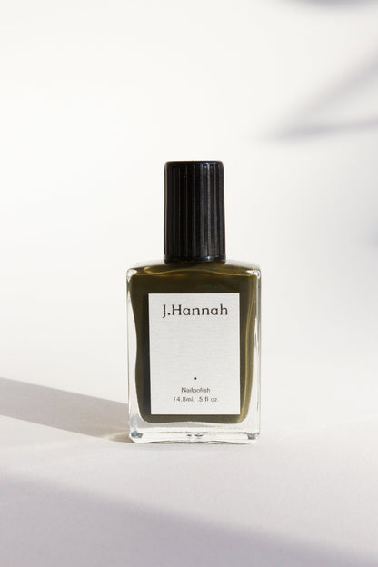 A bottle of dark olive green nail polish by J.Hannah